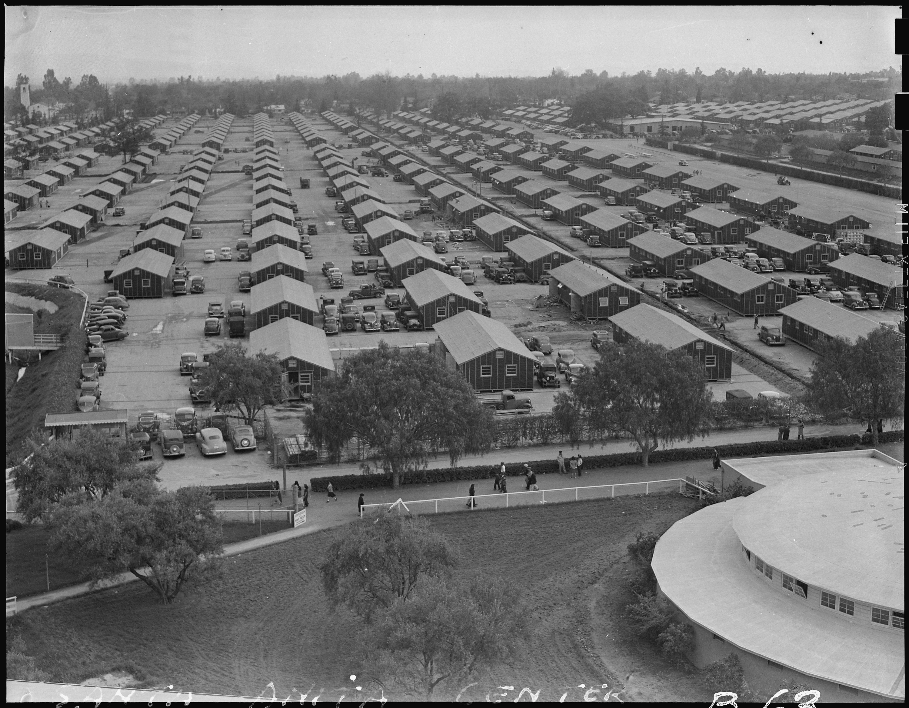 Santa Anita Assembly Center, Arcadia, California. A panoramic view of the Santa Anita assembly center where evacuees from this section await transfer to War Relocation Authority centers to spend the duration. Photo by Clem Albers (NARA record: 8452194).
