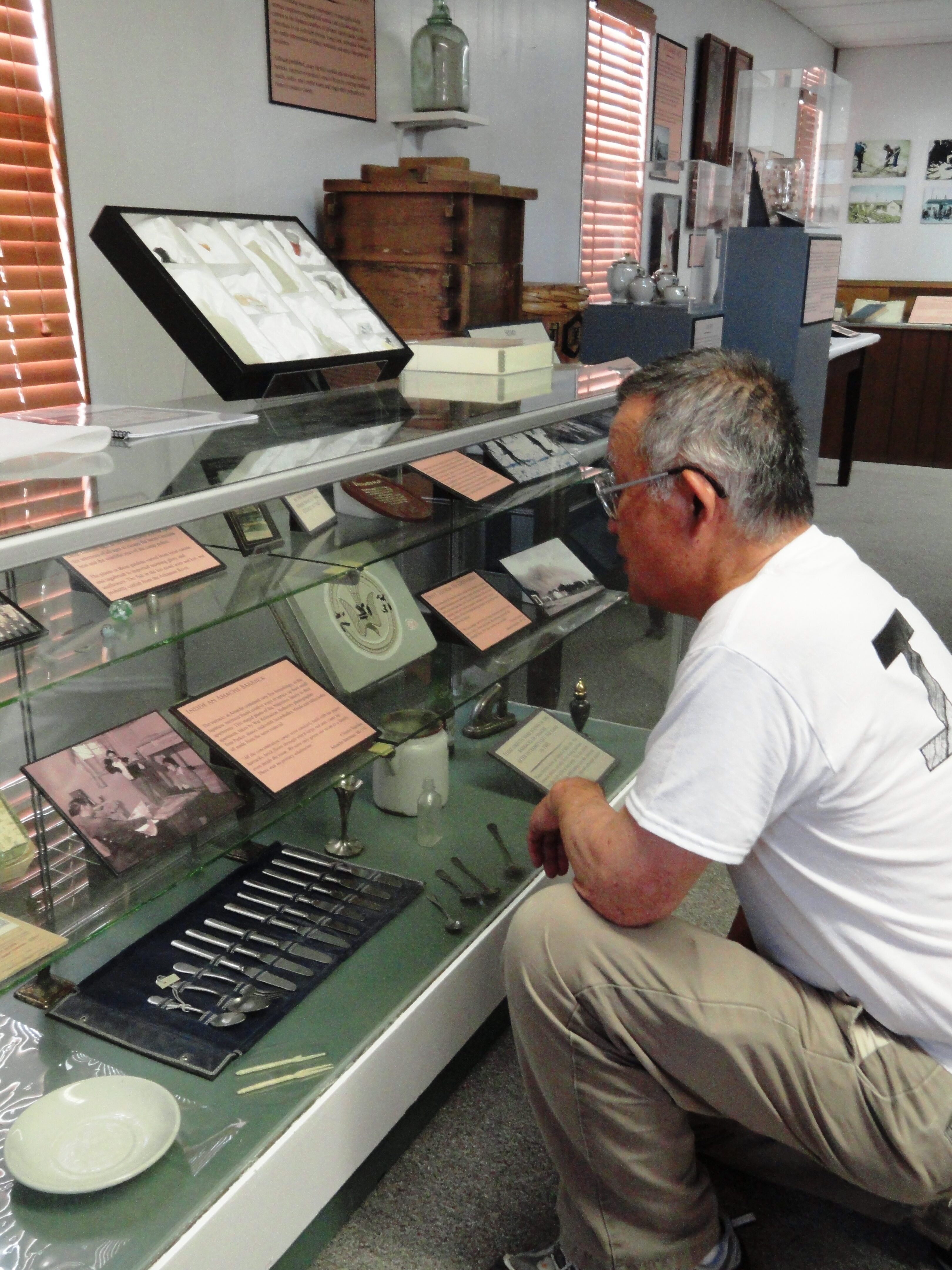 Amache survivor Bill Sueoka reading quotes from his mother in the Amache Museum. Photo by Kirsten Leong.